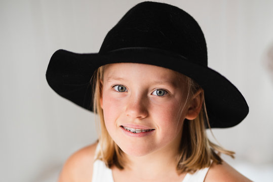 Smiling blonde girl wearing hat