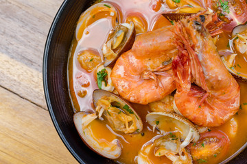 A bowl of fresh tom yum with big size prawn and clams.
