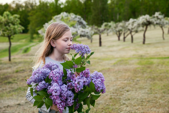 Girl with lilac flowers