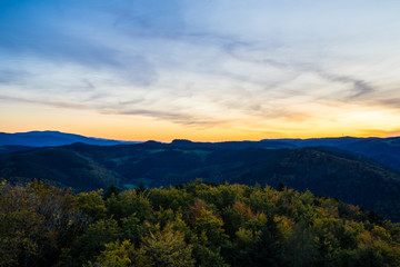 Germany, Perfect aerial view above endless beautiful black forest vacation nature landscape above tree tops at sunset in autumn season perfect for hiking