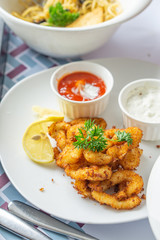 Crispy onion rings served on a white plate