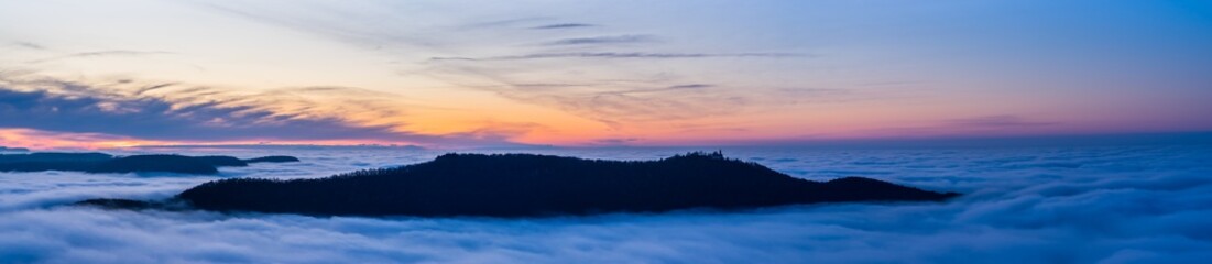 Obraz premium Germany, XXL panorama aerial view above fog clouds in valley of swabian jura nature landscape at sunset near stuttgart on mountain breitenstein with view to castle teck