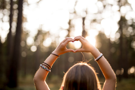 Girl making heart gesture
