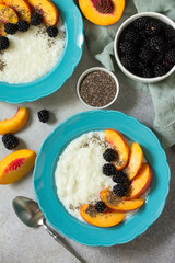 Healthy and vitamin breakfast. Oatmeal with chia, nectarines and blueberries on a stone countertop. Top view on a flat background lay.