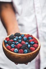 Holding a plate full of berries. Breakfast mix. Raspberries, blueberries, blackberries. plate