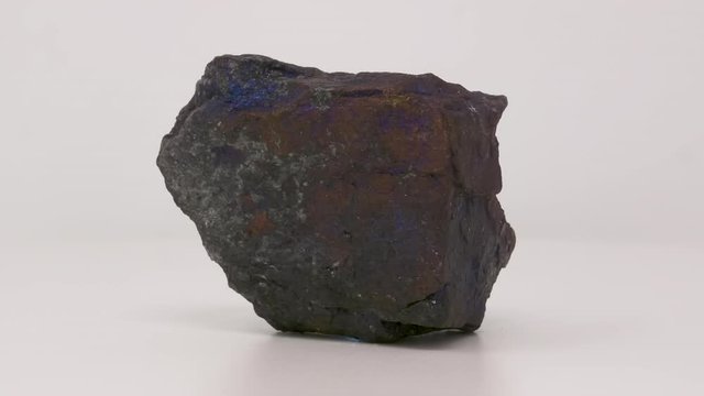 Very close view of Bornite. Peacock ore specimen. Rotating front to back.
