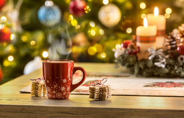 Christmas coffee and advent wreath on table with boheh lights in background