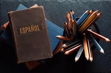 Foto op Canvas learninf Spanish concept. Old books and pencils © spaxiax