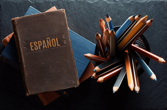 learninf Spanish concept. Old books and pencils