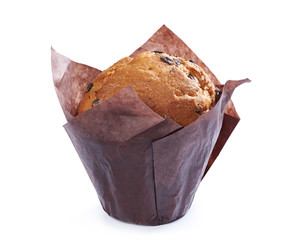 muffin in brown paper with chocolate pieces isolated