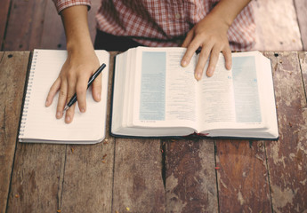 Soft focus young women prayer and read holy bible.bible study concept