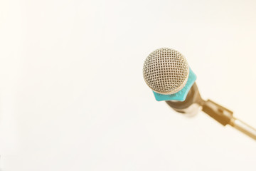 Microphone on abstract blurred at the speech podium