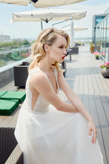 Fototapeta na wymiar Portrait of beautiful bride wearing fashion wedding dress with luxury make-up and hairstyle outdoors. Wedding concept