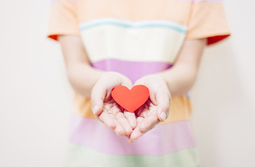 Soft focus Hand giving a red heart 