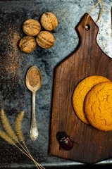 cutting board, cookies, walnuts, on a black background