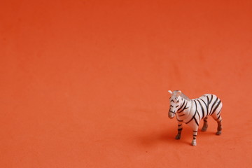 plastic toy with zebra shape in color background