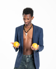 A black guy (man) in a blue jacket and jeans with oranges in his hands