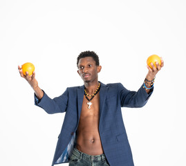 A black guy (man) in a blue jacket and jeans with oranges in his hands