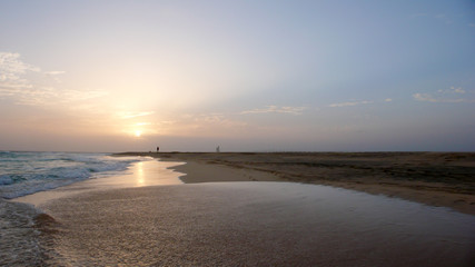 person enjoying an evening walk on a secluded tropical beach in Cape Verde at sunset