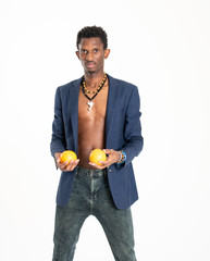 A black guy (man) in a blue jacket and jeans with oranges in his hands
