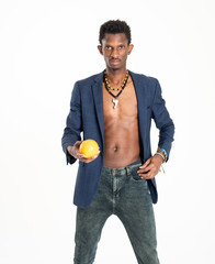 A black guy (man) in a blue jacket and jeans with oranges in his hands