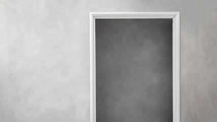 Industrial design concrete walls with minimalist white door frame looking into concrete building.