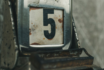 Day 5 number on metal rusty vintage calendar. Bad day concept.