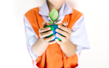 Hands children holding the world made from clay and tree on top, Eco friendly concept