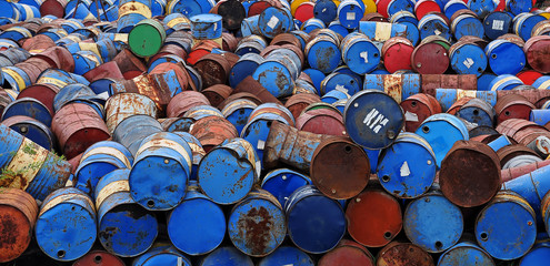  A bunch of colorful old barrels.  Background of multi-colored barrels.