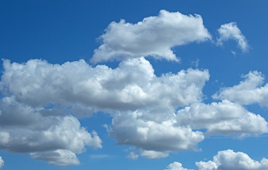 Naklejka na ściany i meble wallpaper of white fluffy clouds in the blue sky