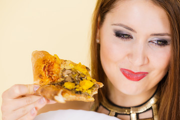 Woman eating hot pizza slice