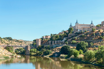 Naklejka premium view from the river bank on the fortress wall and castles of the ancient Spanish city of Toledo