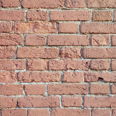 Old brick wall of bricks of different sizes as a background