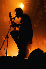 Silhouette of a musician on the stage of a night club.