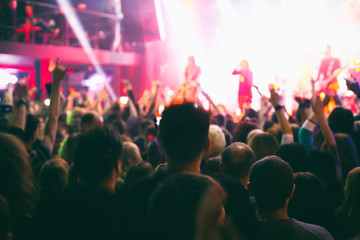 Crowd of spectators having fun at a concert.