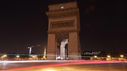 Fototapeta na wymiar Long exposure in Paris Arc de Triomphe (Triumphal Arch) in Chaps Elysees at sunset, Paris, France. Architecture and landmarks of Paris. Postcard of Paris