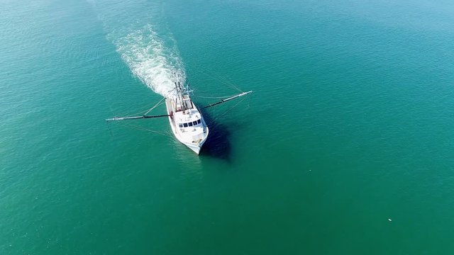 A White Trawling Shrimp Boat on the Ocean, Aerial Circling Point of Interest of the front of the Vessel