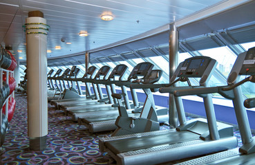 Treadmills in line in Fitness Center Gym on cruise ship liner for Jogging and Walking