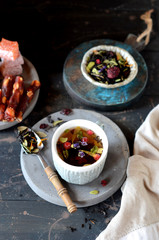 Berry flower tea on a dark wooden background
