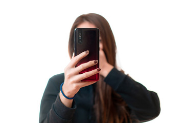 Asian woman record a video by her smarthphone and cover her mouth by her hand with excitement,...
