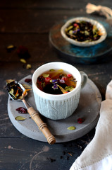 Berry flower tea on a dark wooden background