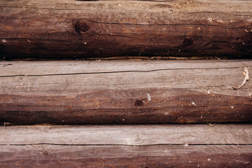 Wooden logs wall of rural house background. The texture of the logs. Background of logs.