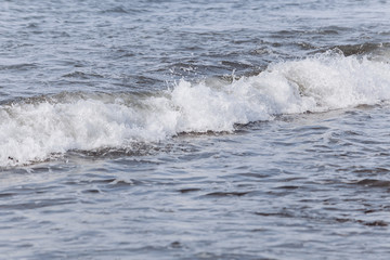 Waves on the beach. A surge of water ashore.