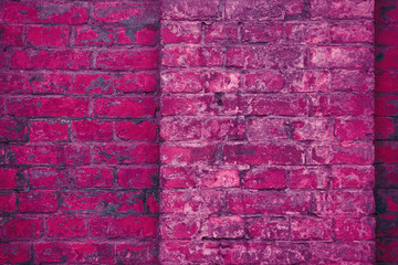 Grunge neon pink brick wall texture background.