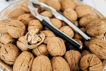 Nutcracker and walnuts in a large bowl