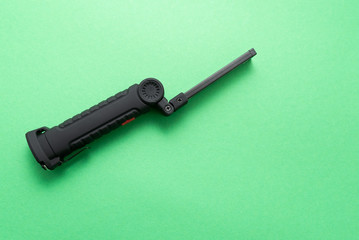 plastic flashlight on green background