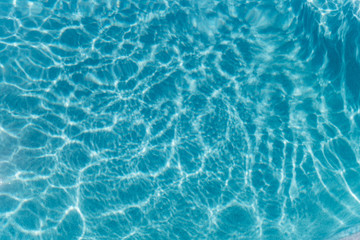 Obraz premium Beautiful refreshing blue swimming pool water. Background of blue water in the pool
