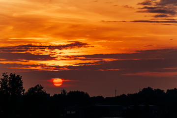 Obraz premium Big Sun on sunset. Nature composition. Orange sunset.