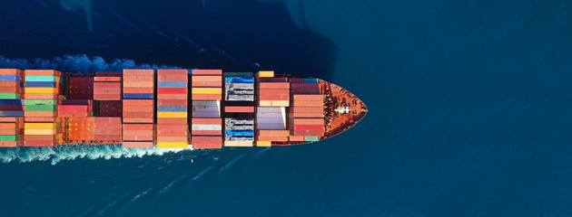 Aerial drone photo of industrial cargo container carrier cruising the open ocean deep blue sea