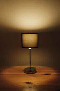 Electric Lamp On The Table Top, Natural Low Key Light. Cozy Bedroom Light At Night, Minimalistic And Sparse Image